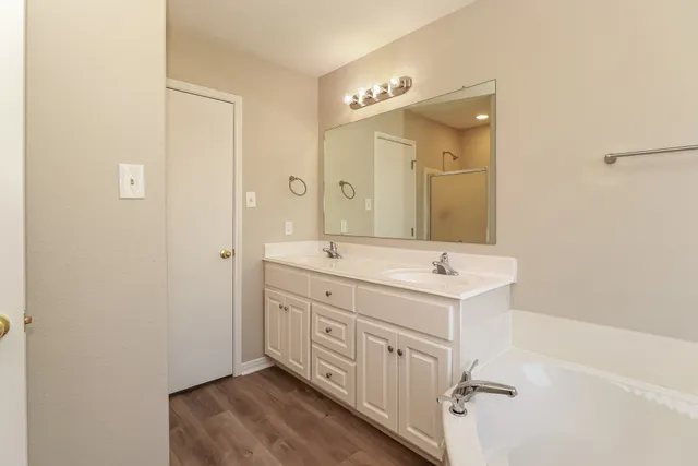 a bathroom with 2 sink mirror and shower