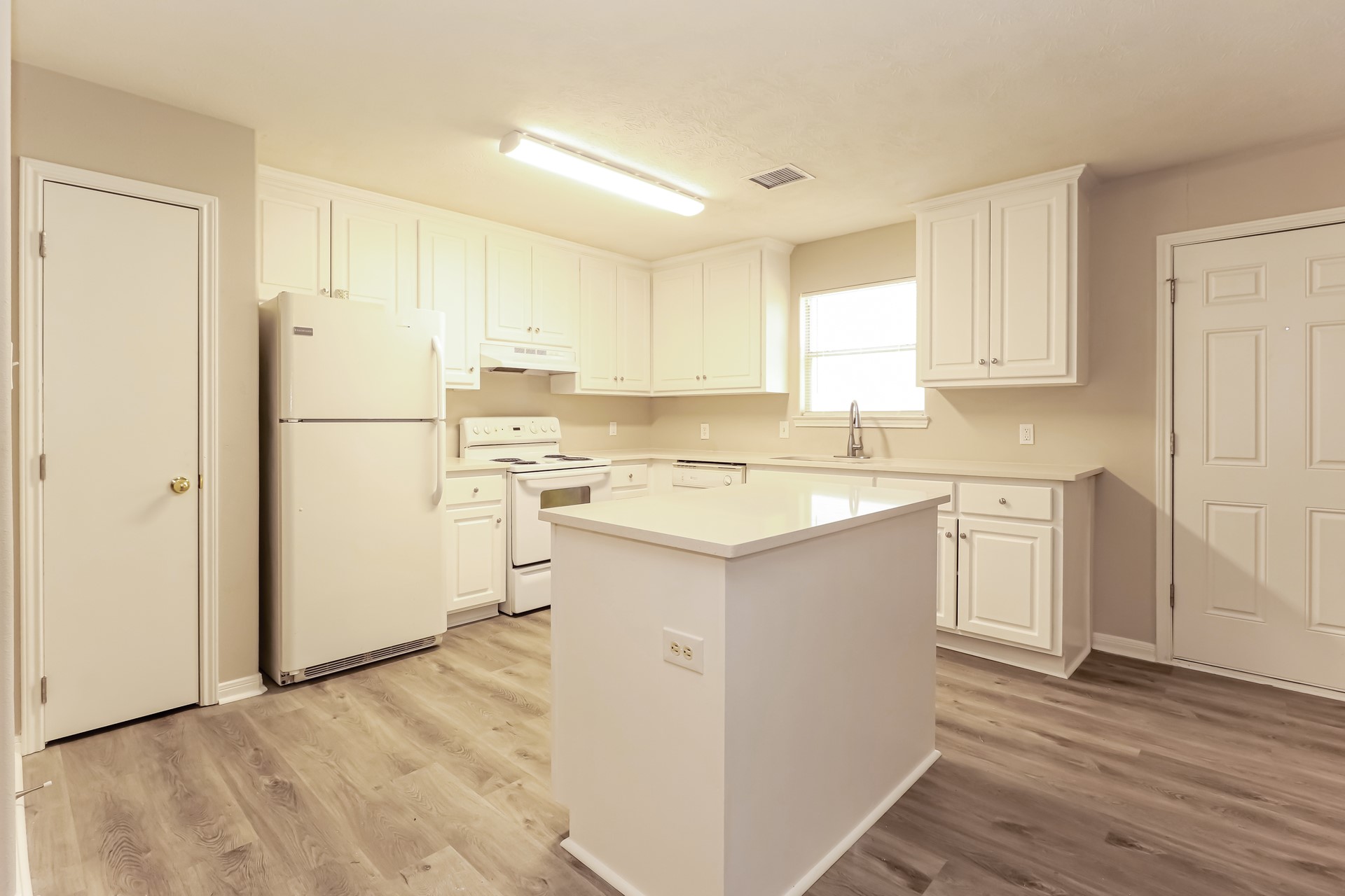 16360 Hidden River Court Conroe, TX 77302 - Photo 7 of 16 a kitchen with a sink a refrigerator a microwave and cabinets