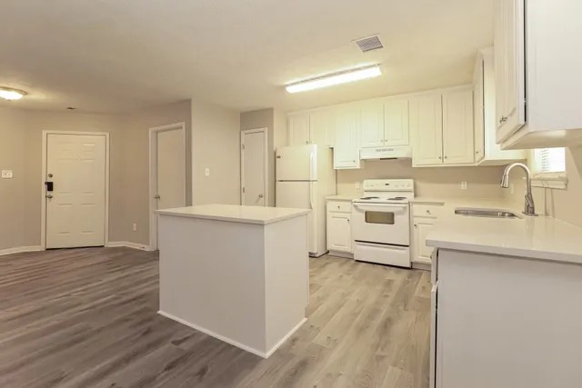 a utility room with cabinets washer and dryer
