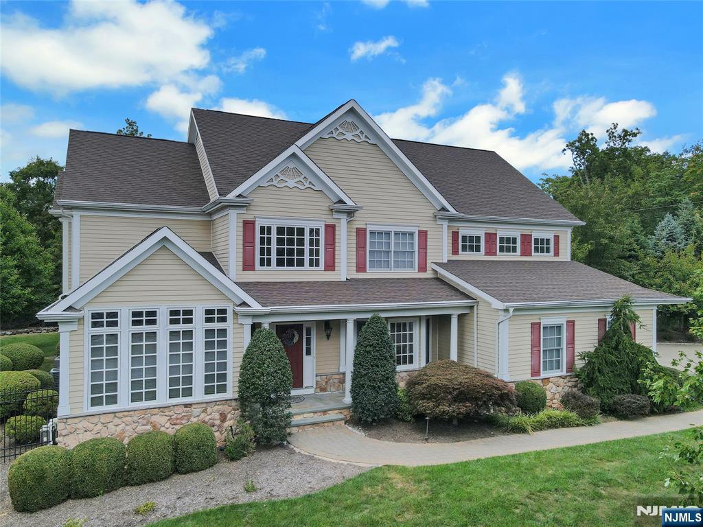 22 Meadowlake Drive Mahwah, NJ 07430 - Photo 35 of 39 a front view of a house with a garden and plants