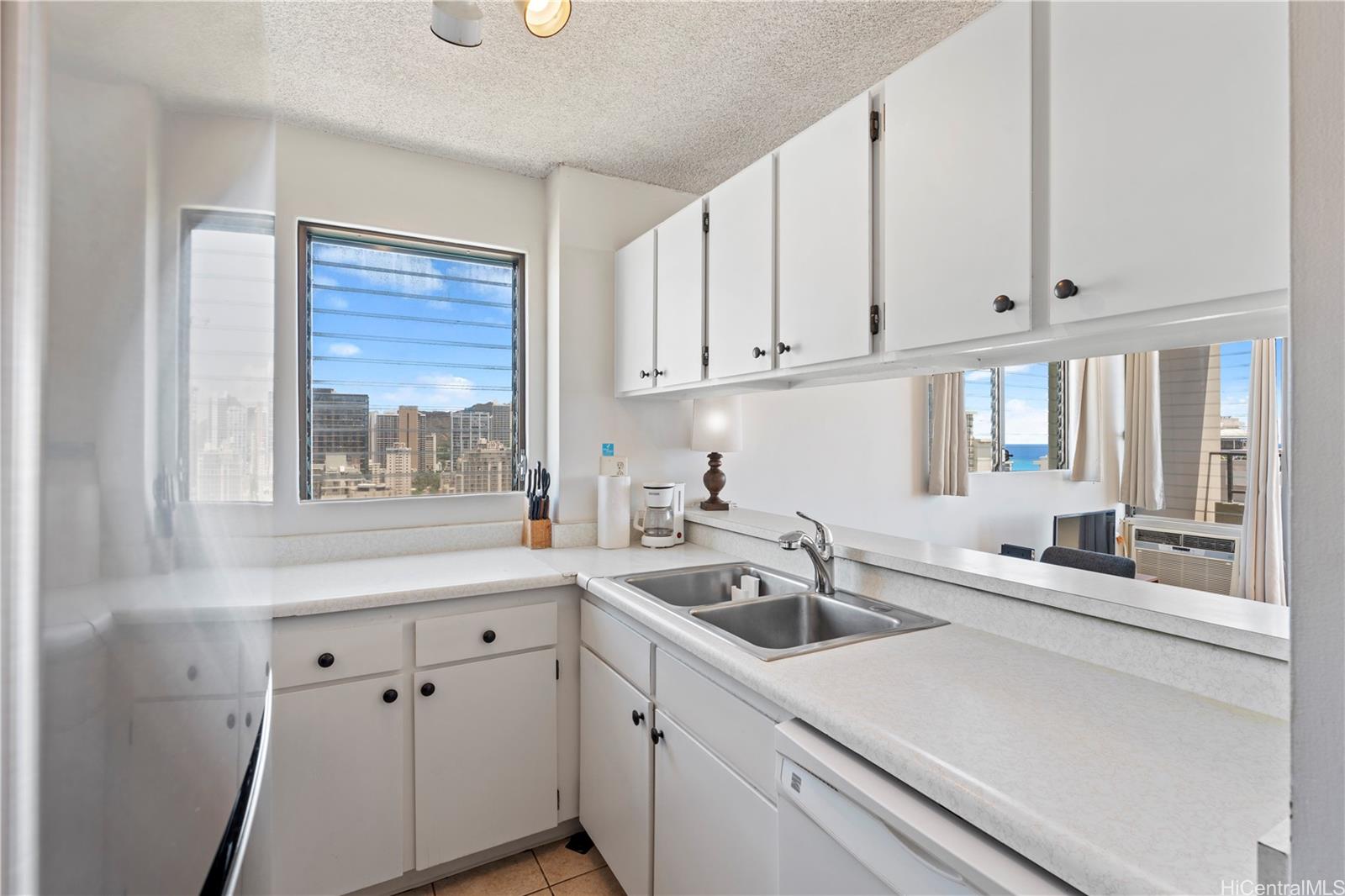 2240 Kūhiō Avenue, Unit 2308 Honolulu, HI 96815 - Photo 6 of 21 a kitchen with a sink cabinets and window