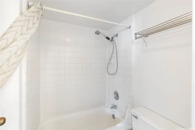 a bathroom with a bath tub with a shower