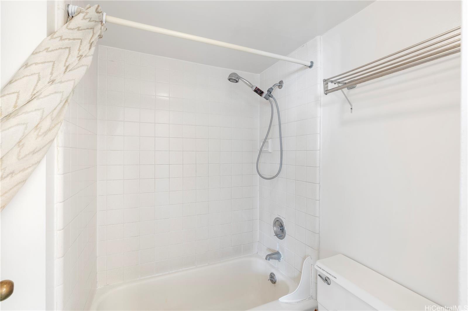 2240 Kūhiō Avenue, Unit 2308 Honolulu, HI 96815 - Photo 8 of 21 a bathroom with a bath tub with a shower