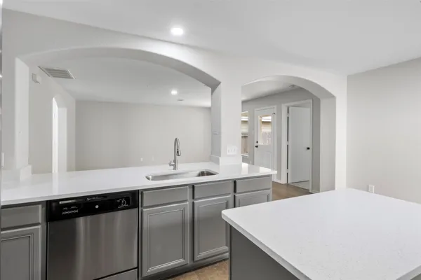 a kitchen with a sink a stove a refrigerator and cabinets