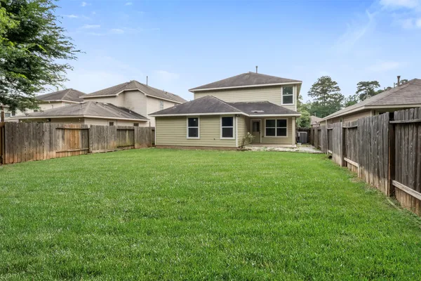 a front view of a house with yard and green space