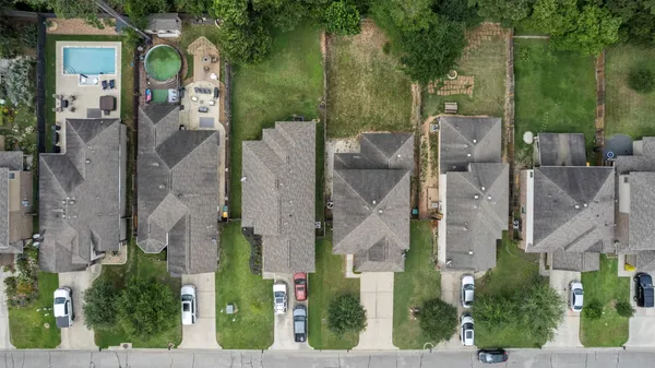 an aerial view of a residential apartment building with a yard
