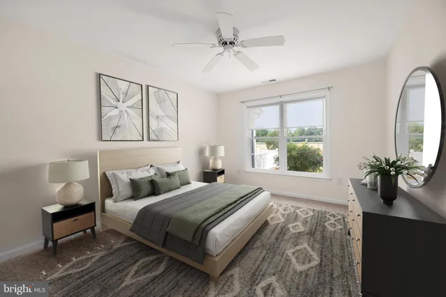 a bedroom with furniture and a large window