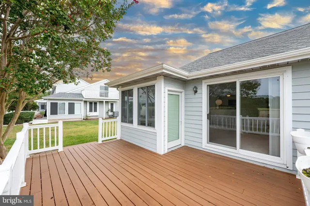 a view of a house with a wooden deck