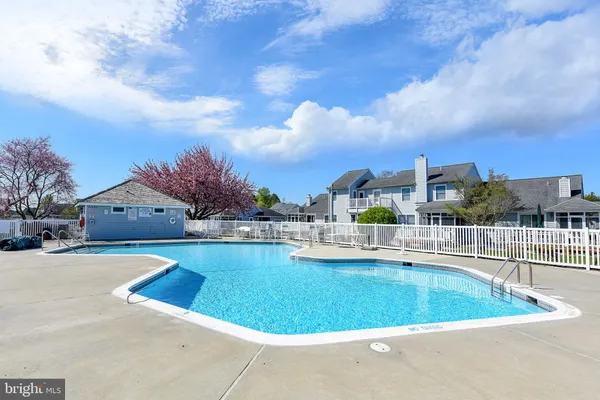 a view of a swimming pool and lounge chair
