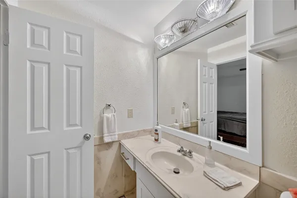 a bathroom with a sink vanity and a mirror