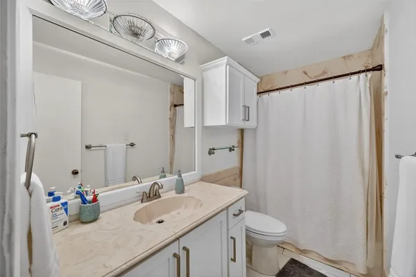 a bathroom with a sink toilet and shower