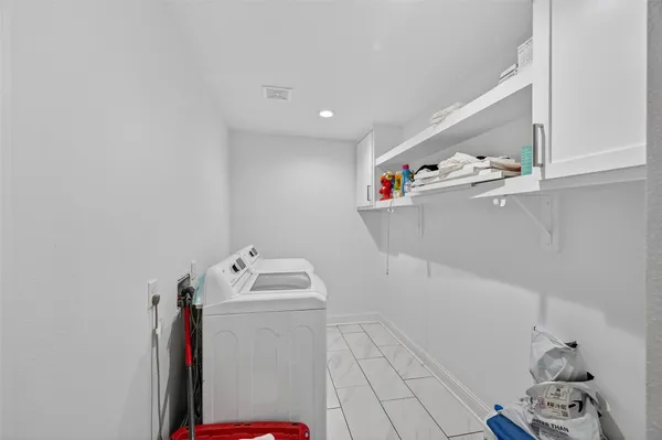 a utility room with sink dryer and washer