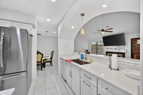 a kitchen with stainless steel appliances a refrigerator and a sink
