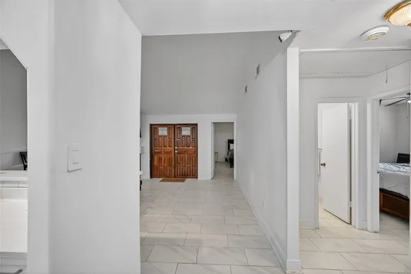 a view of a hallway with closet and a bathroom