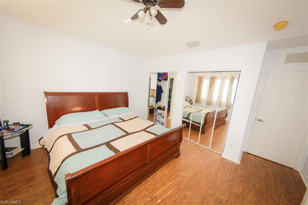 17537 Cherry Ridge Lane Fort Myers, FL 33967 - Photo 12 of 20 a bedroom with a bed and wooden floor