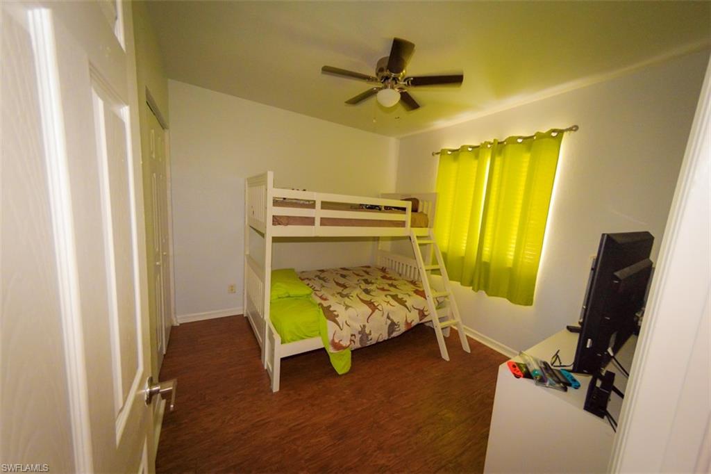 17537 Cherry Ridge Lane Fort Myers, FL 33967 - Photo 17 of 20 a bedroom with a bed and a chandelier