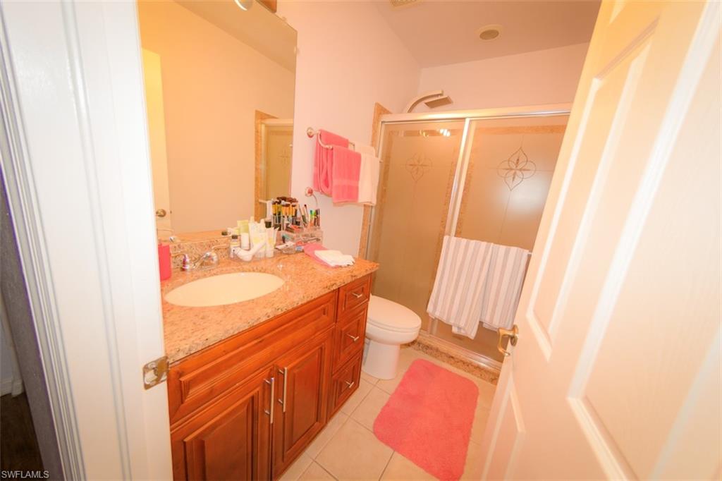17537 Cherry Ridge Lane Fort Myers, FL 33967 - Photo 18 of 20 a bathroom with a sink a mirror and a shower