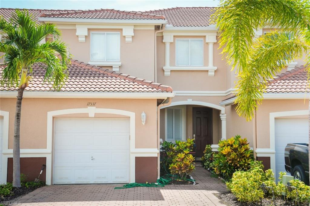 17537 Cherry Ridge Lane Fort Myers, FL 33967 - Photo 2 of 20 a front view of a house with plants