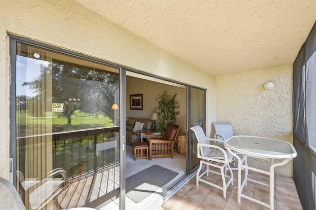 an aerial view of a house with a yard and lake view
