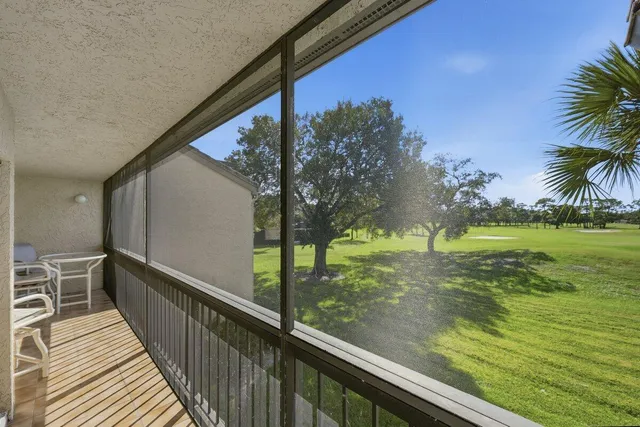 an aerial view of residential houses with outdoor space and ocean view
