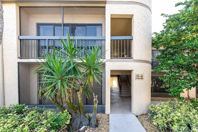 a view of a swimming pool with a lawn chairs under an umbrella