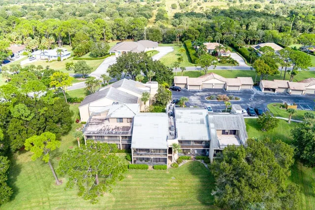 an aerial view of residential houses with outdoor space and swimming pool