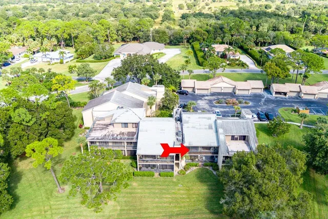 an aerial view of residential houses with outdoor space and swimming pool