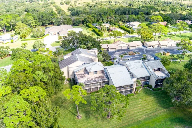 an aerial view of residential houses with outdoor space and river