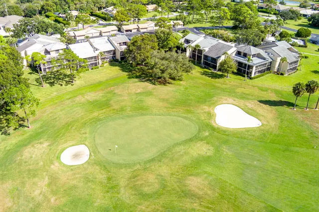 an aerial view of residential houses with outdoor space and swimming pool
