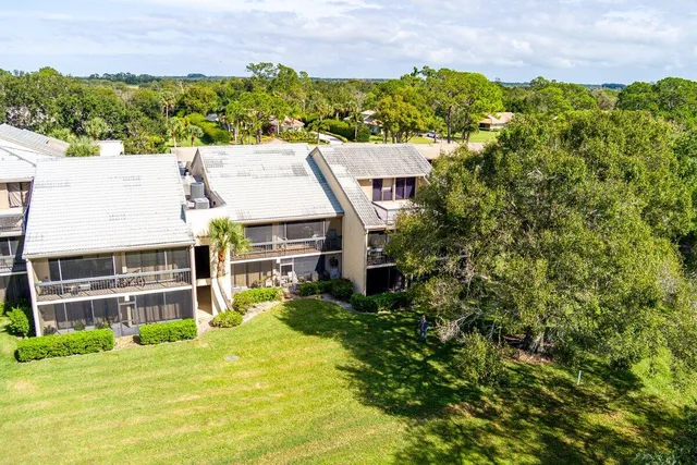 an aerial view of a house with a swimming pool yard and outdoor seating