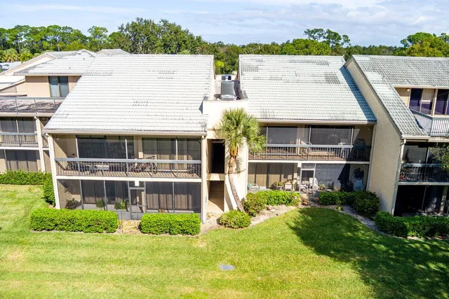 an aerial view of a house with a yard basket ball court and outdoor seating