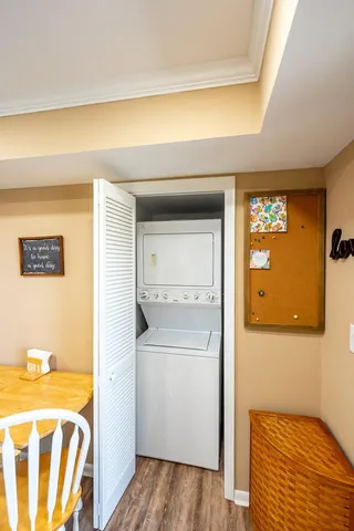a view of a dining room with furniture a chandelier and wooden floor