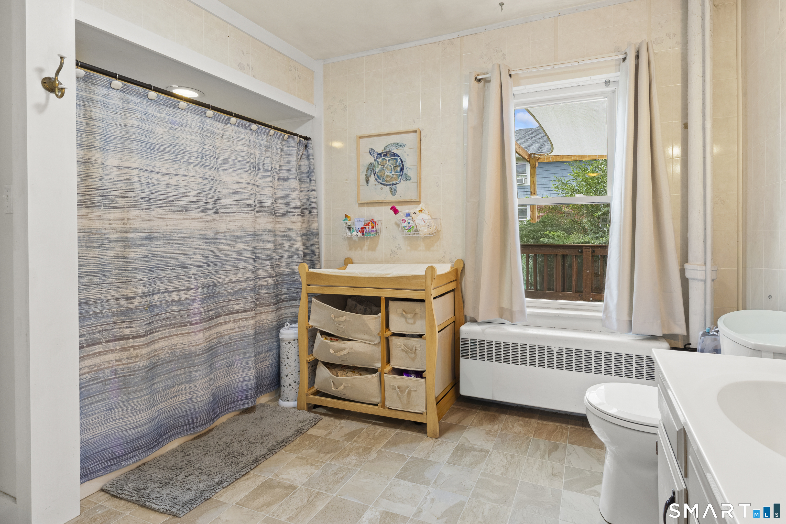 47 Broad Street Killingly, CT 06239 - Photo 14 of 33 a bedroom with a baby bed a couch and a window