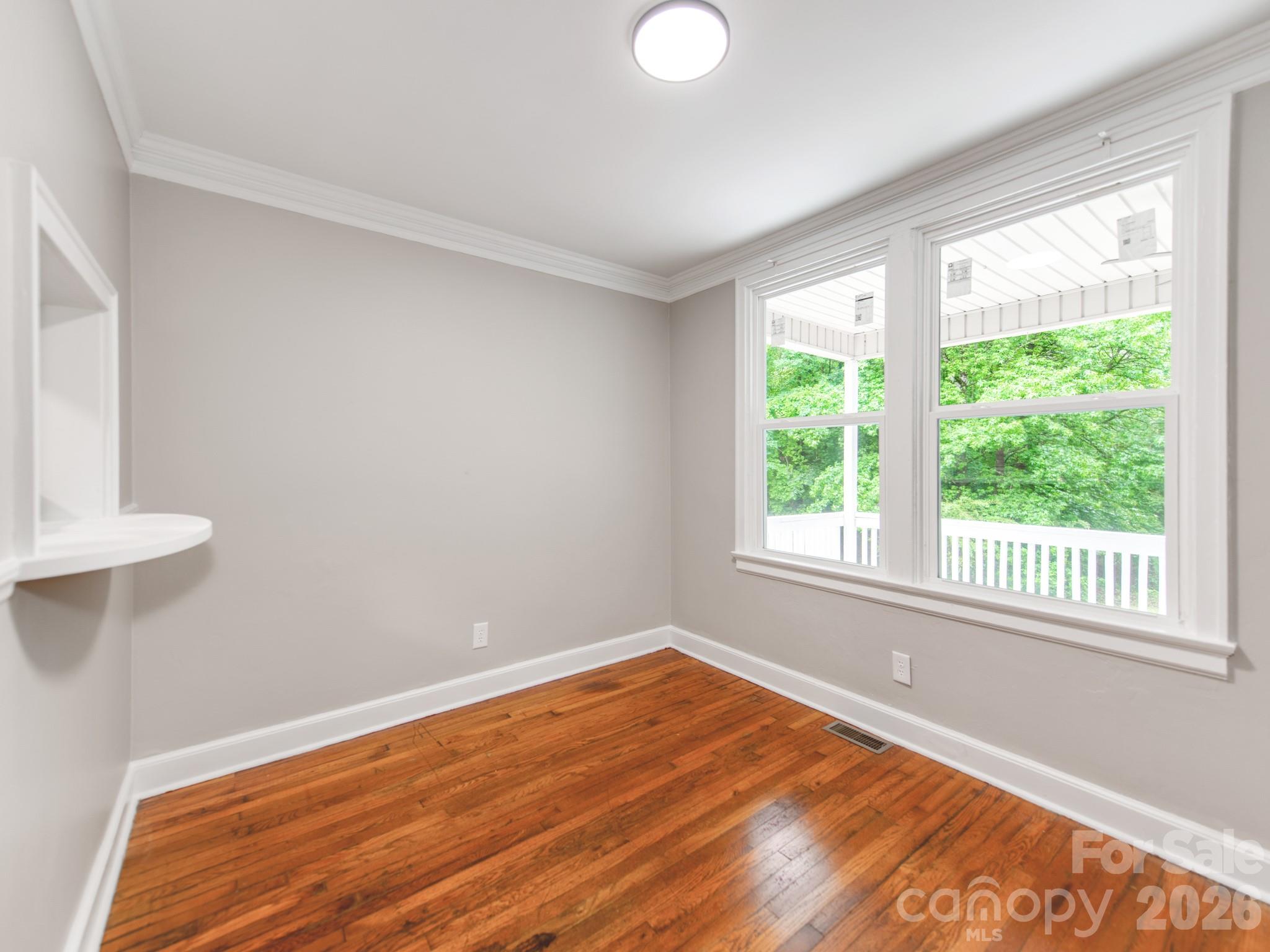 4699 Cherrystone Road Lancaster, SC 29720 - Photo 8 of 28 a view of an empty room with wooden floor and a window