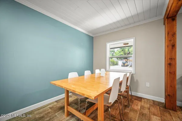 a view of a dining room with furniture and a window