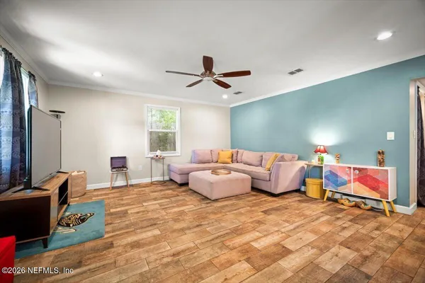 a bedroom with furniture and a flat screen tv