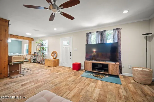a bedroom with furniture and a flat screen tv