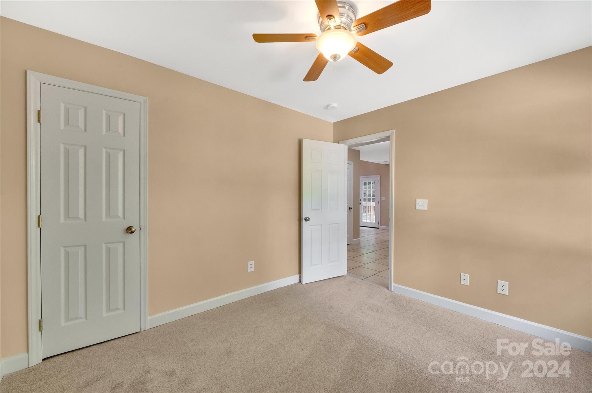 3076 Point Clear Drive Tega Cay, SC 29708 - Photo 15 of 28 an empty room with closet and a chandelier fan