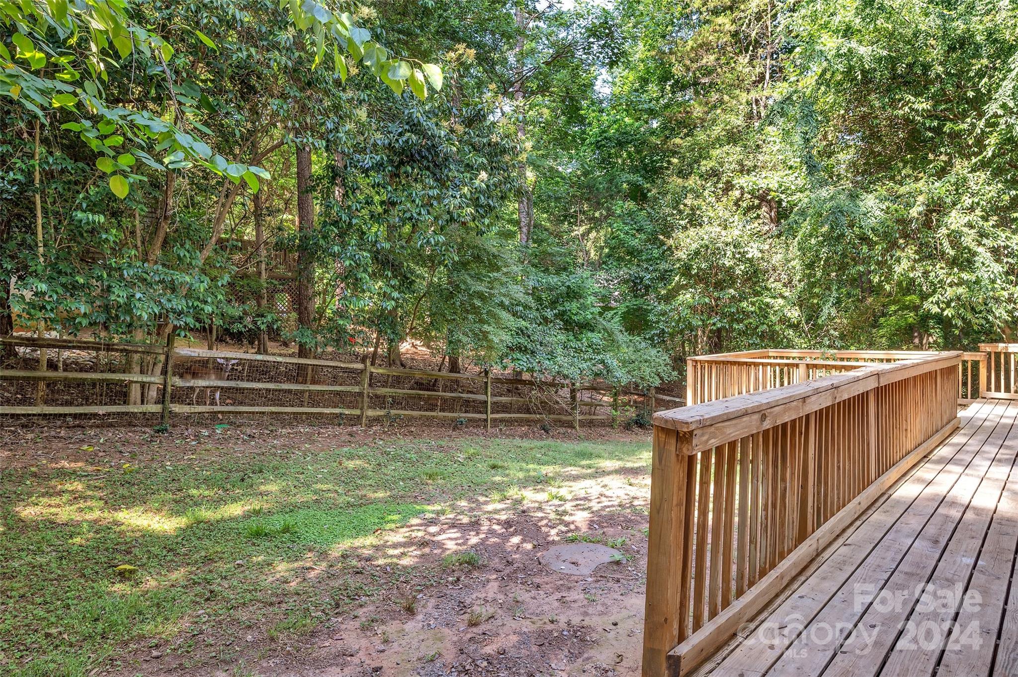 3076 Point Clear Drive Tega Cay, SC 29708 - Photo 20 of 28 a view of a deck with two trees next to a yard