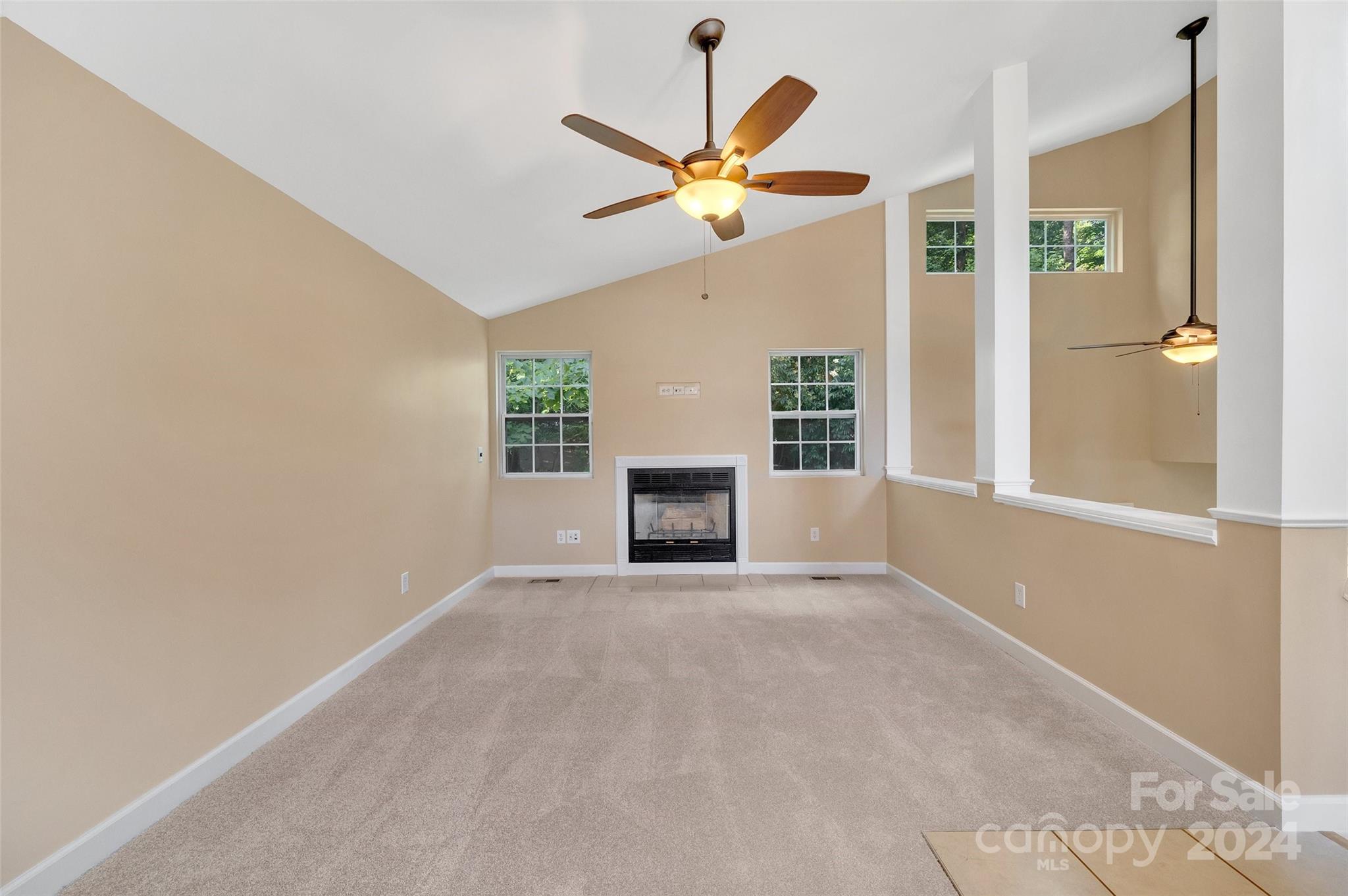3076 Point Clear Drive Tega Cay, SC 29708 - Photo 3 of 28 a view of a livingroom with a ceiling fan and window
