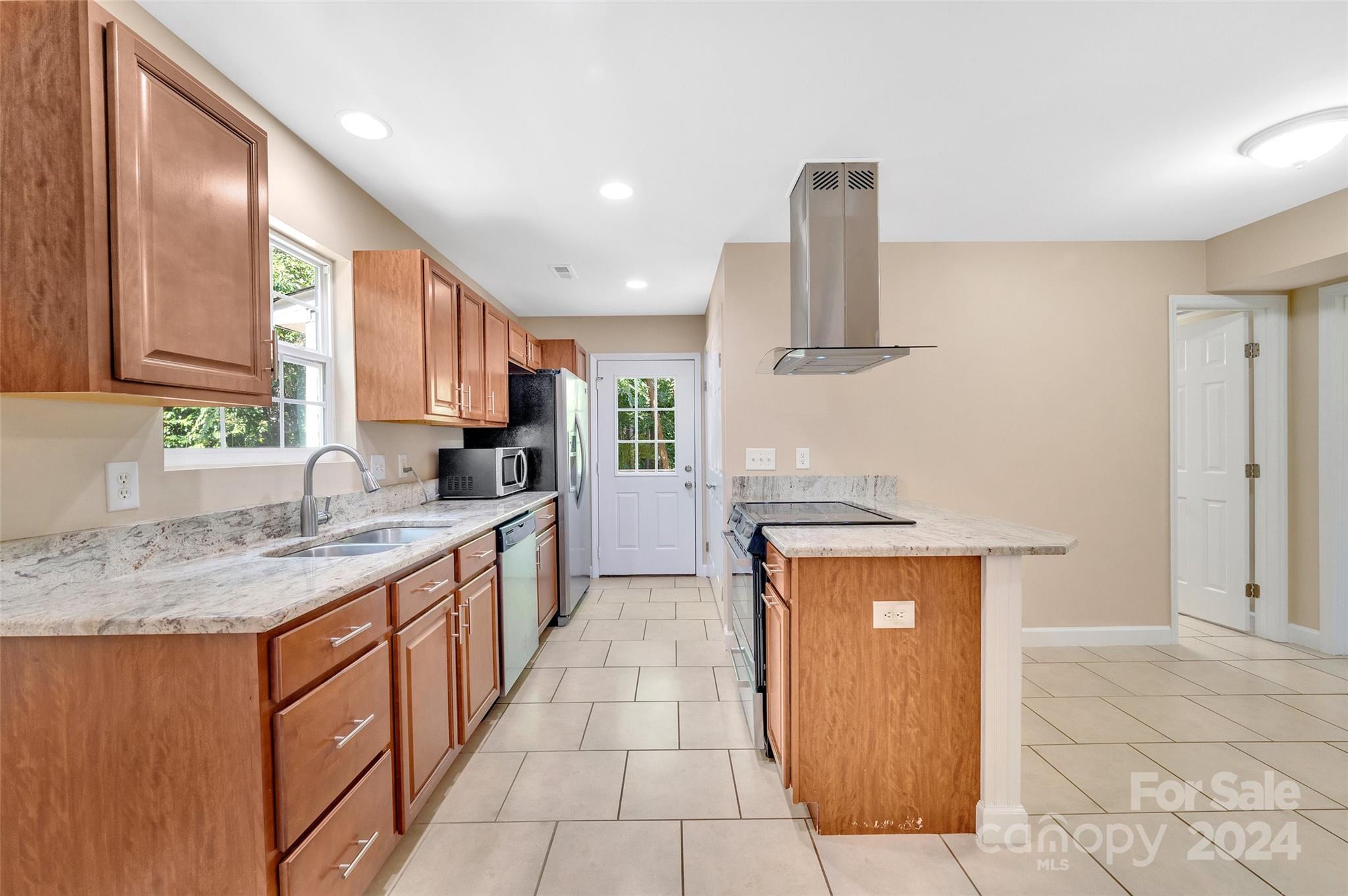 3076 Point Clear Drive Tega Cay, SC 29708 - Photo 6 of 28 a kitchen with stainless steel appliances granite countertop a sink stove and refrigerator