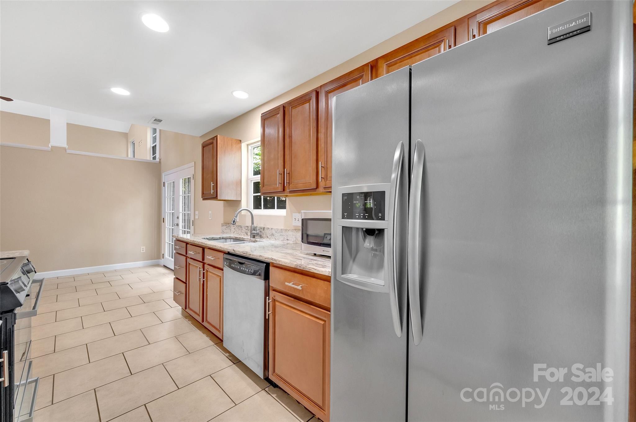 3076 Point Clear Drive Tega Cay, SC 29708 - Photo 7 of 28 a kitchen with stainless steel appliances granite countertop a refrigerator and a sink