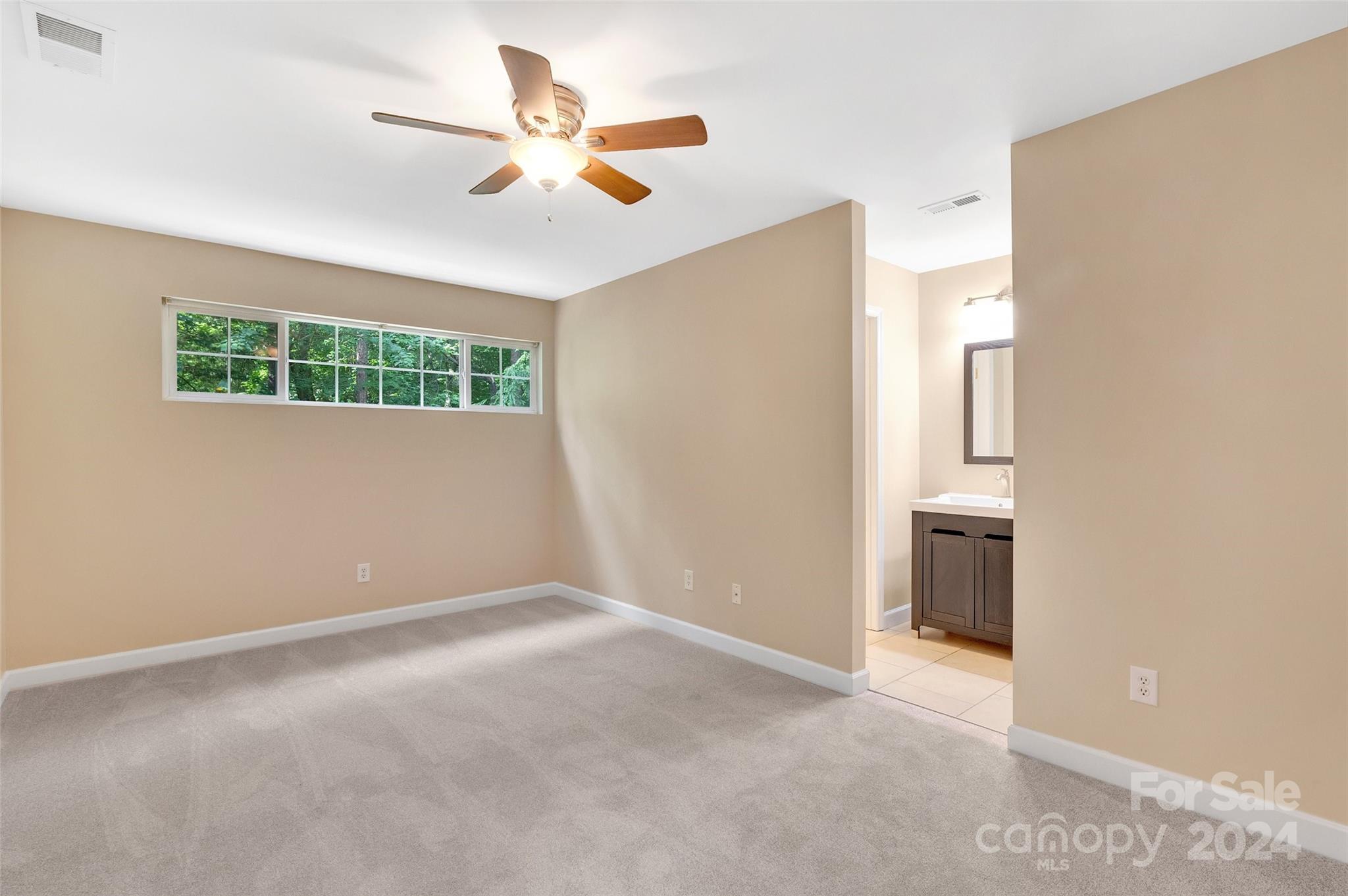 3076 Point Clear Drive Tega Cay, SC 29708 - Photo 10 of 28 a view of an empty room with a ceiling fan