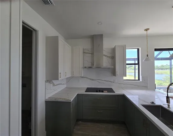 a kitchen with a sink stove and cabinets