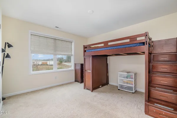 a bedroom with bed and storage