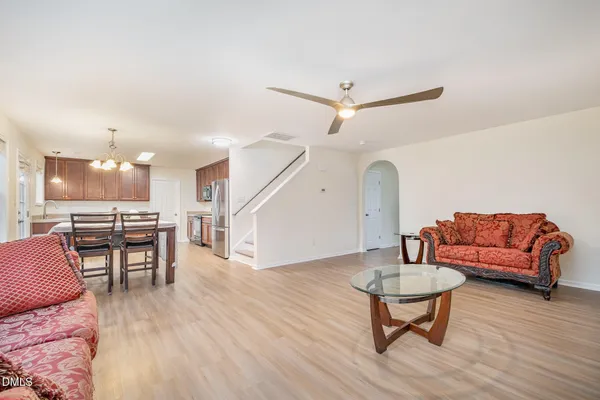a living room with furniture and a wooden floor