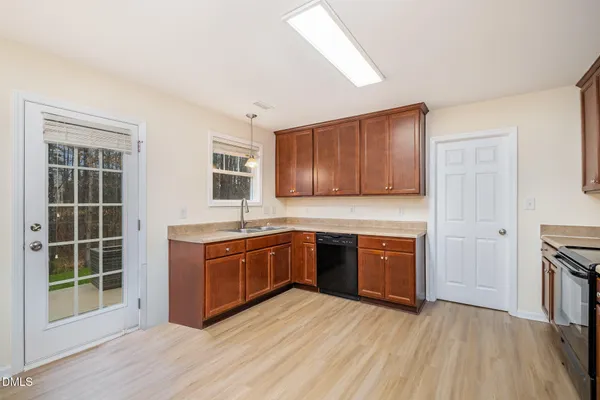 a large kitchen with stainless steel appliances granite countertop a stove and a sink