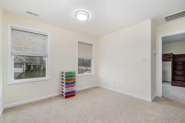 a bed room with a bed and a window