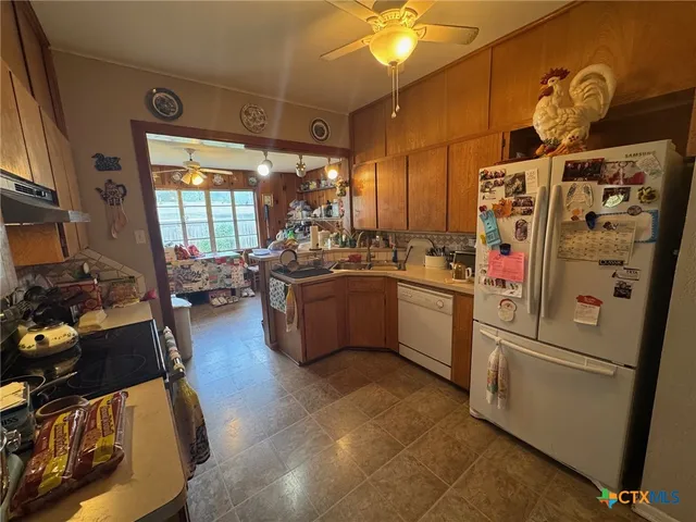 a kitchen with refrigerator a stove a sink and a refrigerator