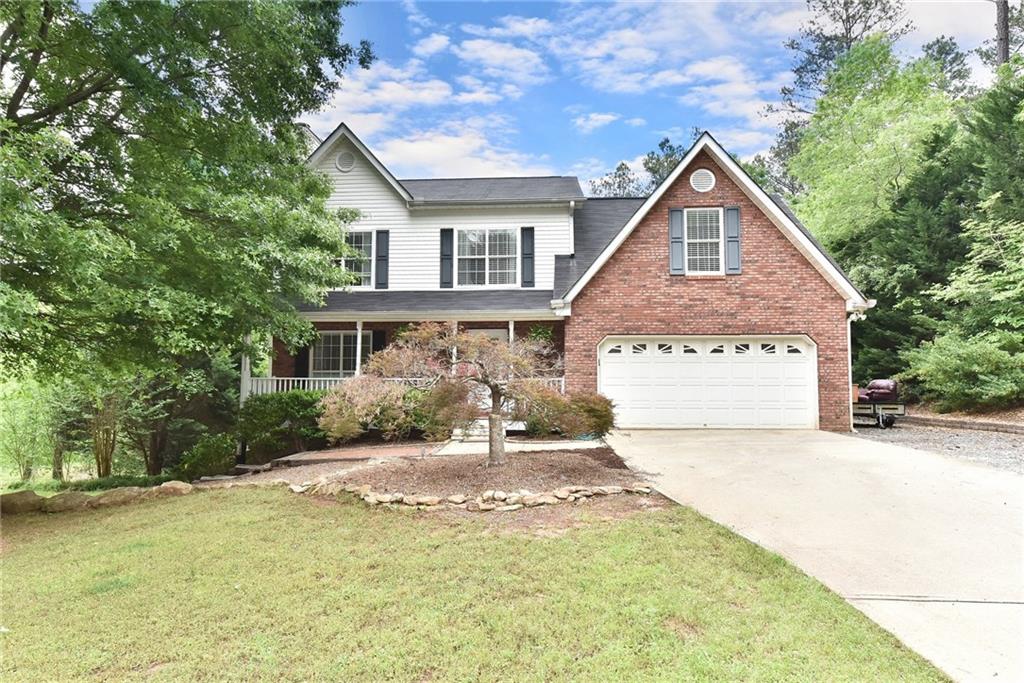 1710 River Bluff Road Monroe, GA 30656 - Photo 1 of 1 a front view of a house with a yard and garage
